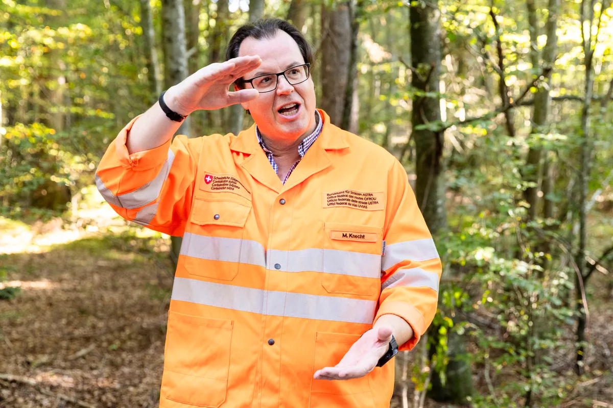 Ein Mann steht im Wald.